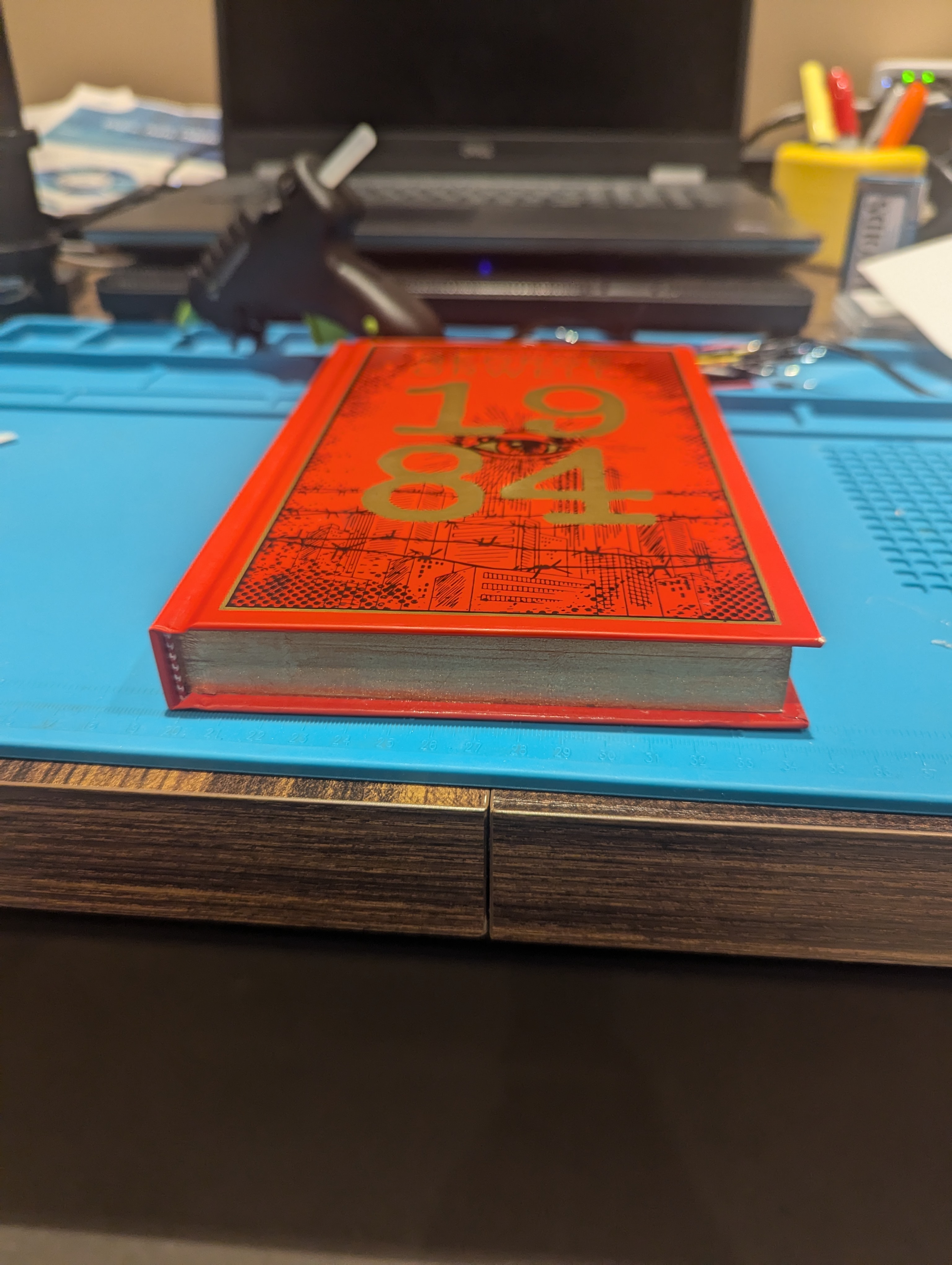 Finished book closed on desk — looks like a normal hardcover from the side